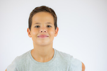 Young pretty boy posing at studio. Photo of preschooler 9 years old over white background