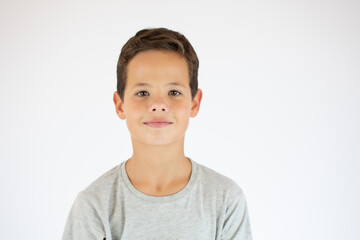 Young pretty boy posing at studio. Photo of preschooler 9 years old over white background