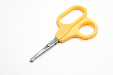 Yellow baby scissors on a white background
