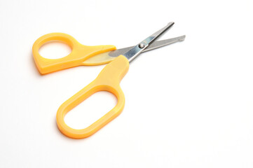 Yellow baby scissors on a white background