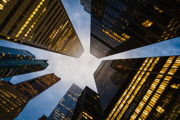 Business and finance concept, looking up at modern office building architecture and high rise corporate buildings in the financial district, Downtown Toronto, Ontario, Canada.