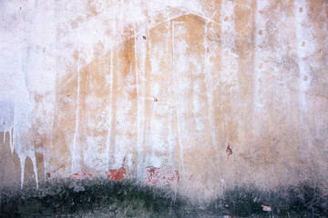 Abstract concrete, weathered with cracks and scratches. Remains of paint different colors on wall....