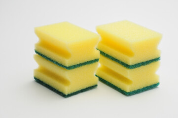 Sponge for washing dishes and plumbing on a white background