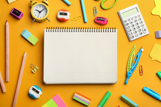 Blank notebook and school stationery on orange background, flat lay with space for text. Back to school