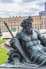 Antique Bronze sculpture at water parterre in Gardens of Versailles. France.