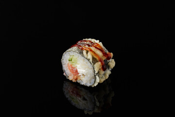Maki - squid, avocado, snow crab, blue cheese sauce, masago, wasabi on black background