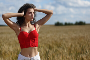 Naklejka na ściany i meble Girl in a wheat field, summer