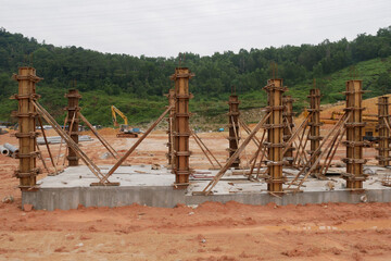 KUALA LUMPUR, MALAYSIA -SEPTEMBER 19, 2020: Column timber form work and reinforcement bar at the construction site. Installed by construction workers. The structure supported by temporary wood support