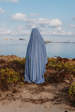 Woman In Ghost Costume Standing On Beach