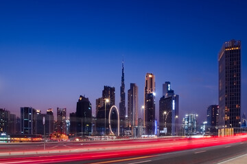 Fototapeta na wymiar Light Trails and Dubai skyline at night