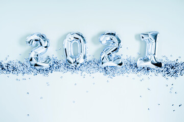 Happy New Year 2021. Foil balloons in form of numbers 2021. New year celebration. Blue Air Balloons on pale blue background. Flat lay, top view, copy space