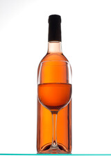 Close-up of a glass of wine with a wine bottle