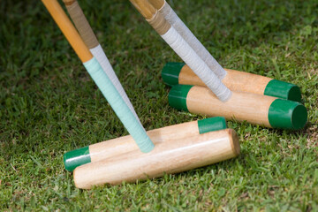 Close-up of four polo mallets 