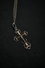 Fototapeta na wymiar Cross with chain on a dark background.