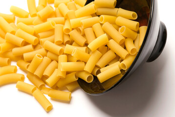 Close-up of a spilled bowl of raw rigatoni pasta