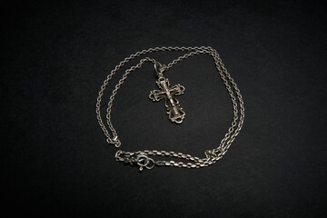 Cross with chain on a dark background.