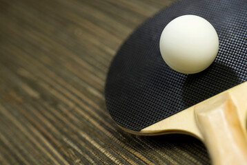 Close-up of a table tennis ball with a table tennis racket 