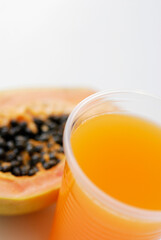 High angle view of a glass of juice with a papaya