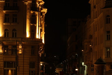 Fototapeta na wymiar A beautiful old hotel building in Warsaw illuminated at night