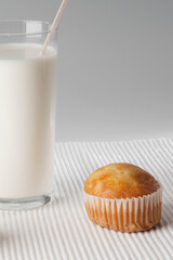 Close-up of a glass of milk and a cupcake