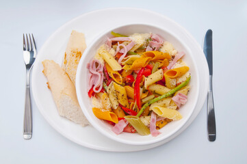 High angle view of a bowl of penne pasta and ham salad