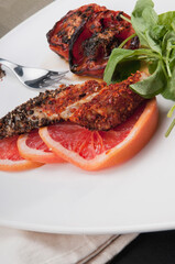 Close-up of pepper coated chops with grapefruit
