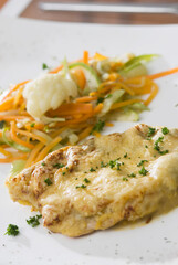 Close-up of fried fish with salad on a plate