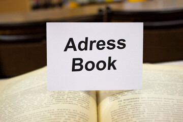 Adress books written in white note on open books