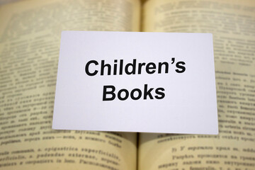Children's books written in white note on open books