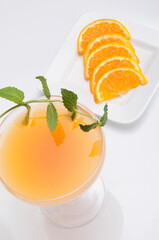 Close-up of a glass of orange juice with orange slices