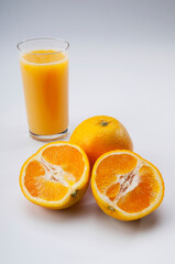 High angle view of oranges with a glass of orange juice