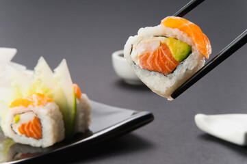 Close-up of sushi held with chopsticks