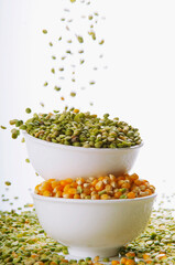 Close-up of bowls of green lentils and corn kernels