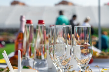 Champagne glasses. Fragment of table setting in the open air.