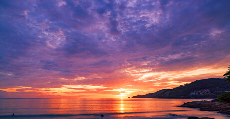 Landscape Long exposure of majestic clouds in the sky sunset or sunrise over sea with reflection in the tropical sea.