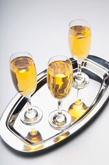 High angle view of three glasses of champagne on a tray