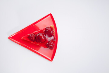 High angle view of a slice of strawberry cheesecake