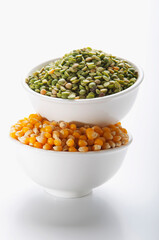 Close-up of bowls of green lentils and corn kernels