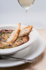 Close-up of a baked dish served with white wine