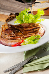 High angle view of a pork steak served with red wine
