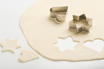 Two pastry cutters on dough