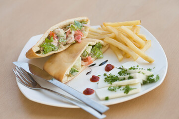 Stuffed pita sandwiches served with French fries