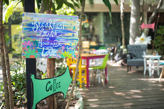Photo of Colorful Entrance Sign of an Alice in Wonderland Themed Restaurant