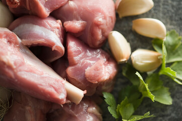 Close-up of mutton with garlic cloves and herbs