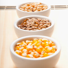 Close-up of bowls of corn and lentils with soybean