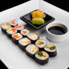 Close-up of sushi rolls with soy sauce and wasabi paste