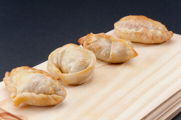 Close-up of fried panzerottis with tortellini on a cutting board