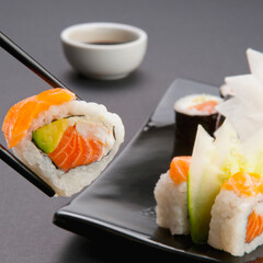 Close-up of sushi held with chopsticks