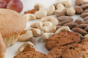 Close-up of dry fruits with cookies and muffins