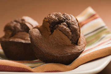 Close-up of two chocolate muffins on a plate